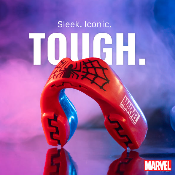 Red and blue mouthguard with Marvel logo on a reflective surface and colorful background