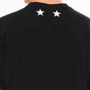 Black t-shirt with white stars on the back against a white background