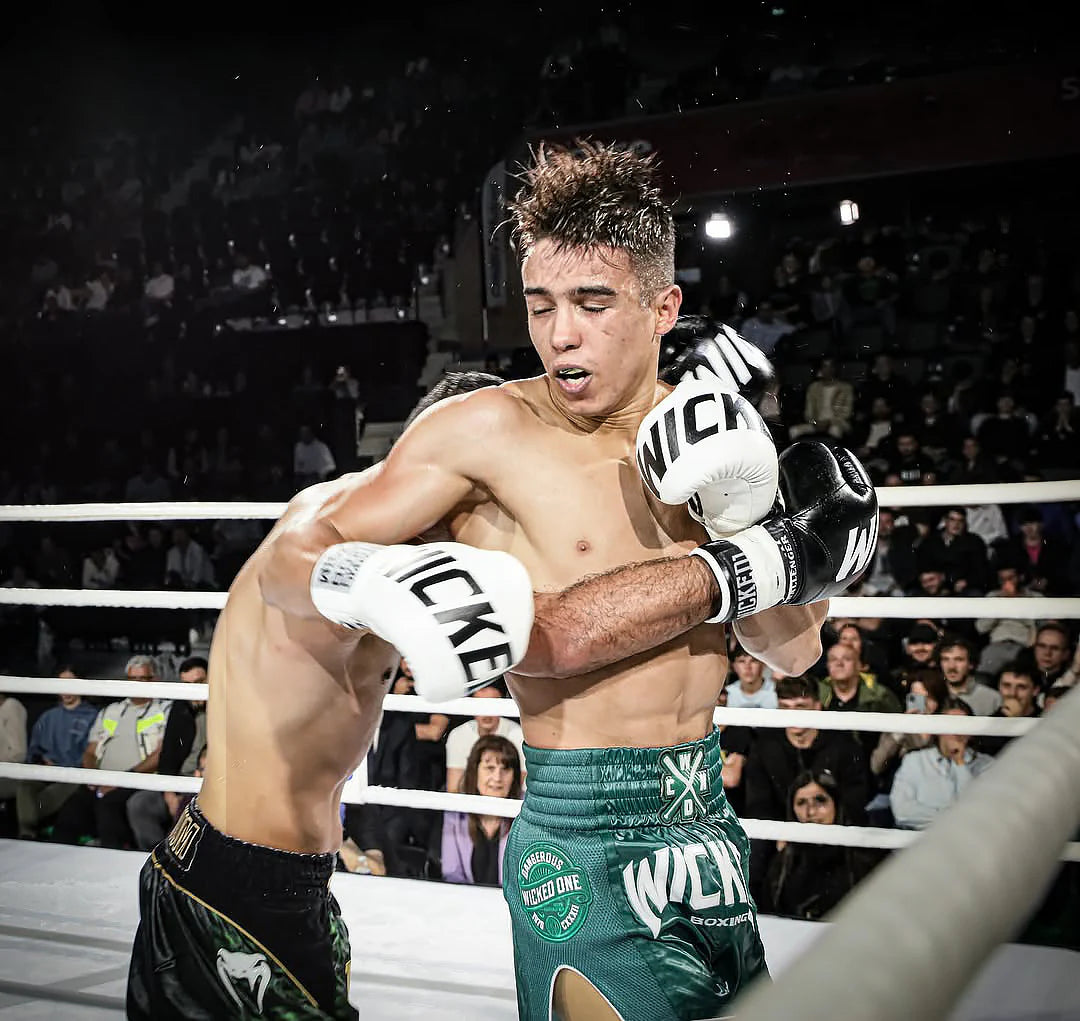 Boxer in action during a match with 'Nike' branded gloves and shorts.