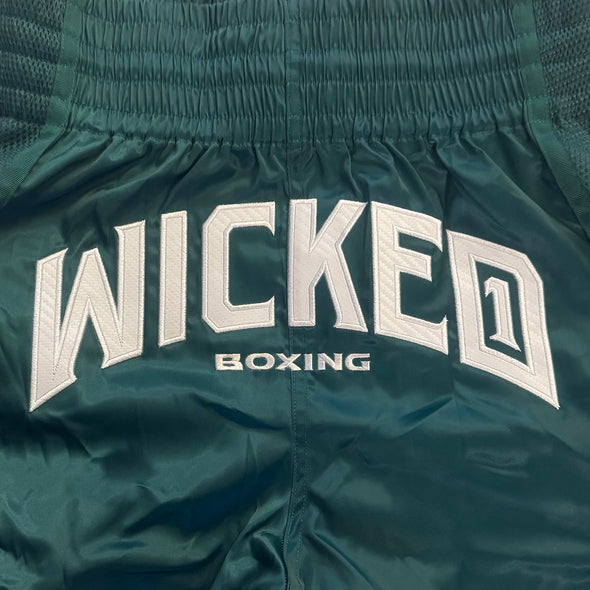 Green boxing shorts with 'WICKED BOXING' text on a close-up view