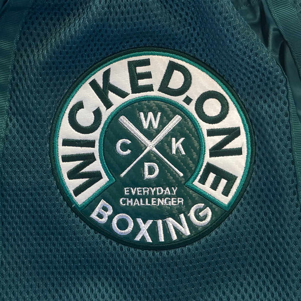 Wicked One Boxing logo on a green textured background