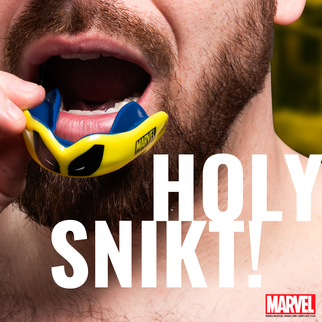 Person wearing a blue and yellow mouthguard with 'Marvel' branding, text overlay 'HOLY SNIKT!'