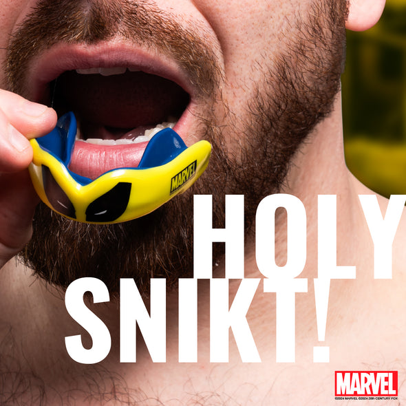 Person wearing a blue and yellow mouthguard with 'Marvel' branding, text overlay 'HOLY SNIKT!'