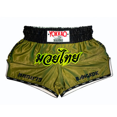 Green boxing shorts with black waistband featuring Yokkao branding on a white background