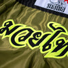 Green shorts with black and yellow text and a brand logo on a white background