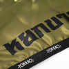 Close-up of a green mat with 'YOKKAO' branding on a white background