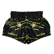 Black shorts with neon green patterns and star designs on a white background