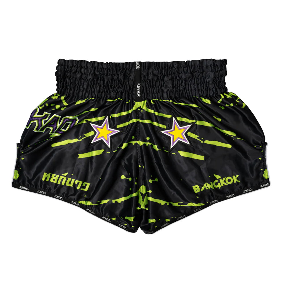 Black shorts with neon green patterns and star designs on a white background