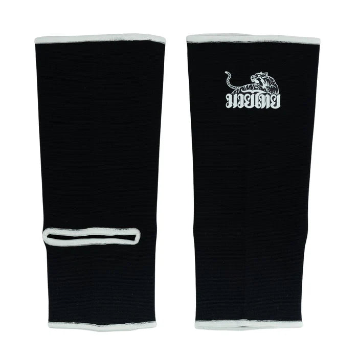 Black shin guards with a white logo on a white background