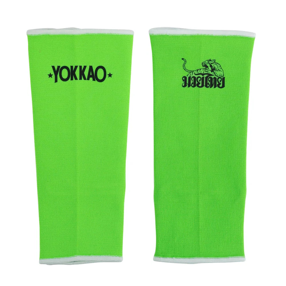 Pair of green athletic sleeves with Yokkao logo on a white background