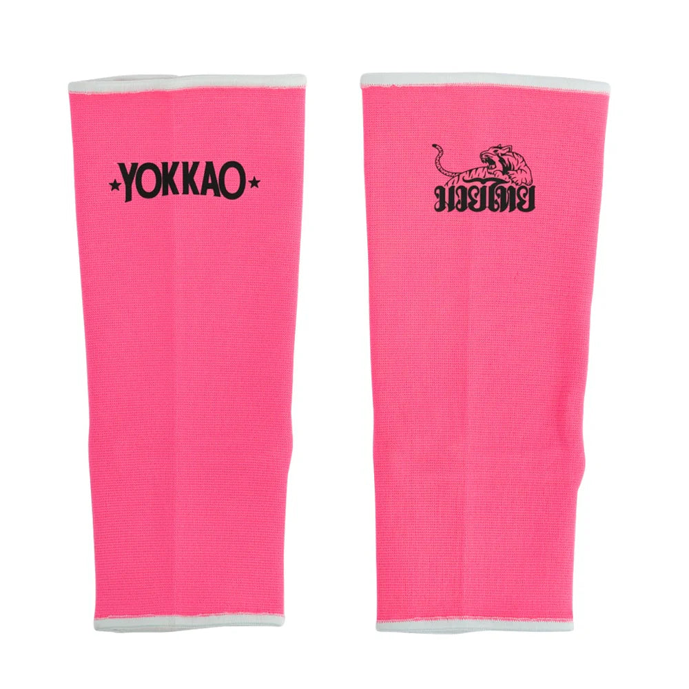 Pair of pink protective gear with Yokkao logo on a white background