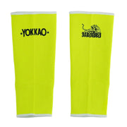 Pair of bright yellow leg sleeves with 'Yokkao' branding on a white background