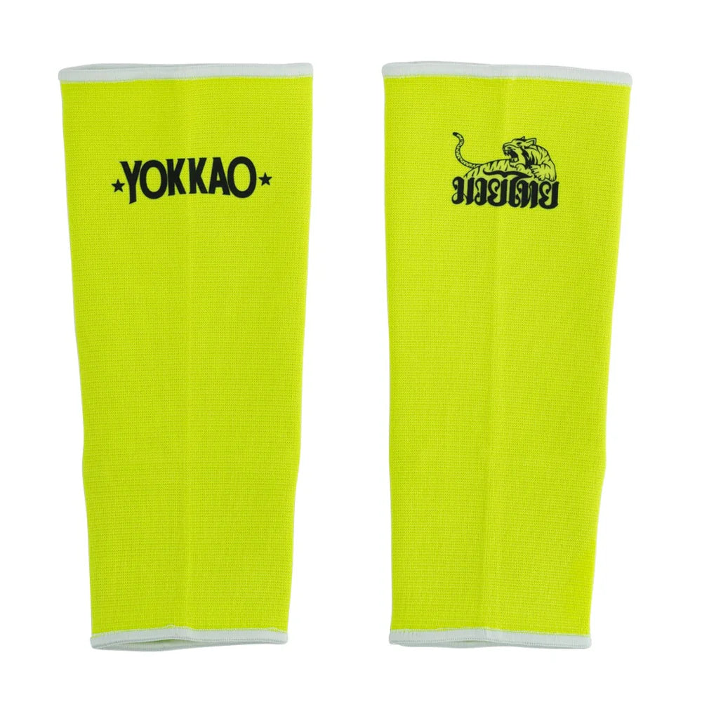 Pair of bright yellow leg sleeves with 'Yokkao' branding on a white background