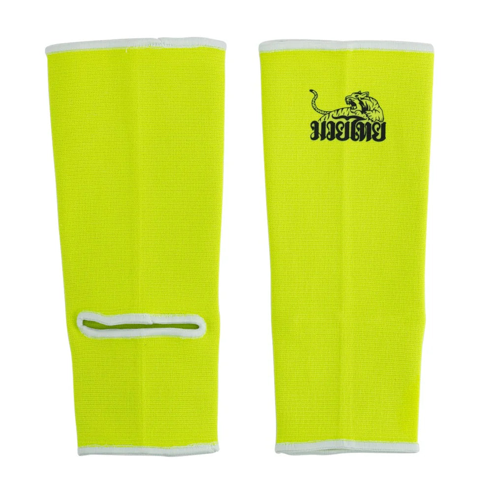 Pair of bright yellow shin guards with a logo on a white background