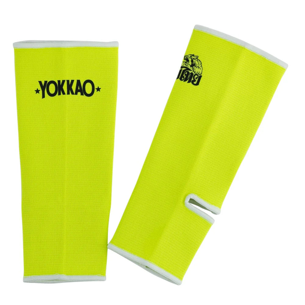 Pair of bright yellow arm sleeves with Yokkao branding on a white background