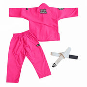 A bright pink martial arts uniform set laid flat on a white background, including a long-sleeve top with a visible 'BABY BRAWLERS' logo on the chest, matching pants, and a white belt with a black tab.