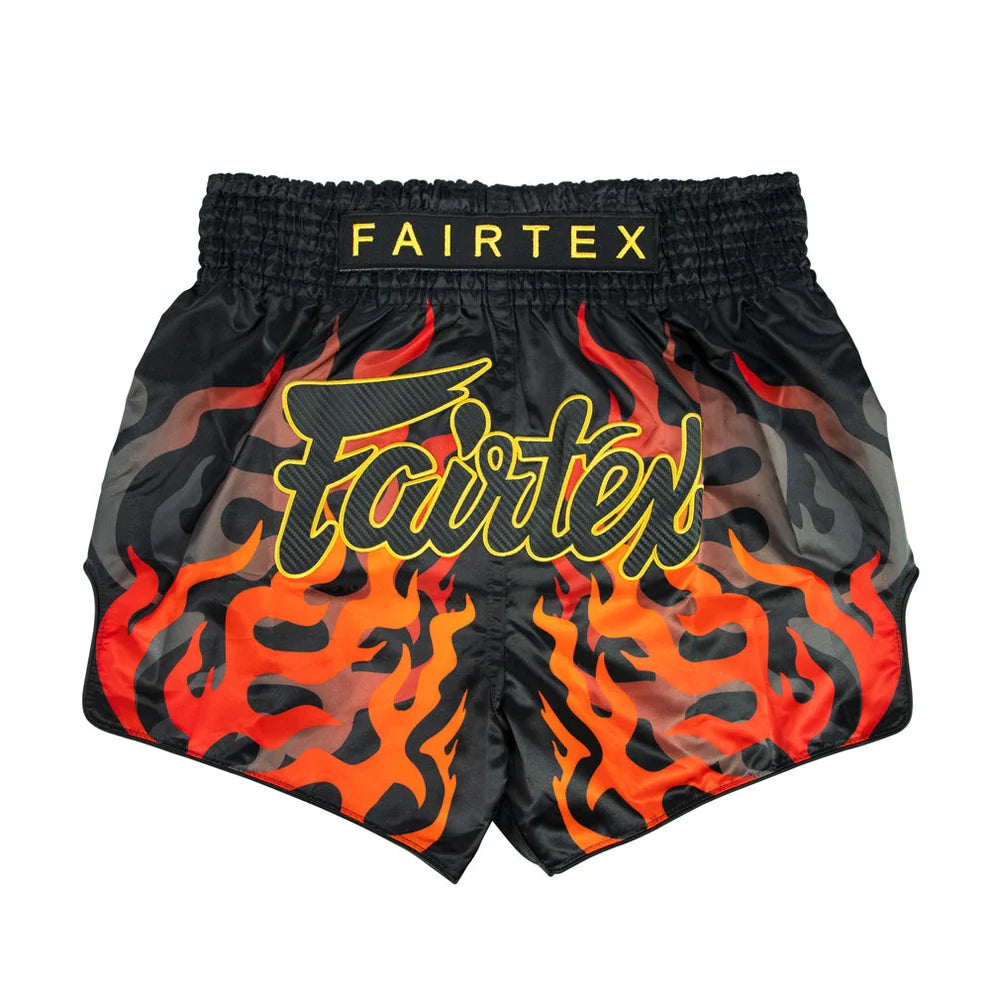 Black boxing shorts with red flames and Fairtex logo on a white background