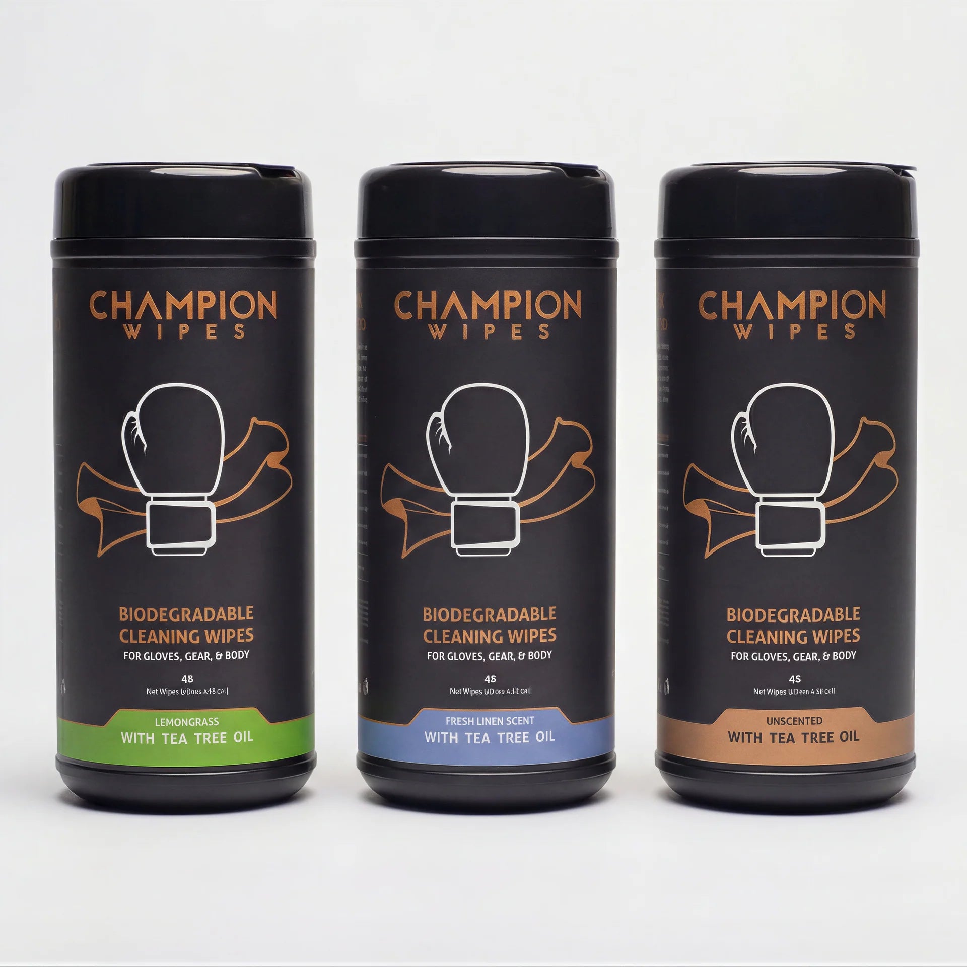 Three black cylindrical canisters of Champion Wipes biodegradable cleaning wipes arranged side by side on a light gray background. The left canister is labeled 'Lemon草ase with Tea Tree Oil' with a green band, the middle is 'Fresh Lemonade with Tea Tree Oil' with a blue band, and the right is 'Unscented with Tea Tree Oil' with a brown band.