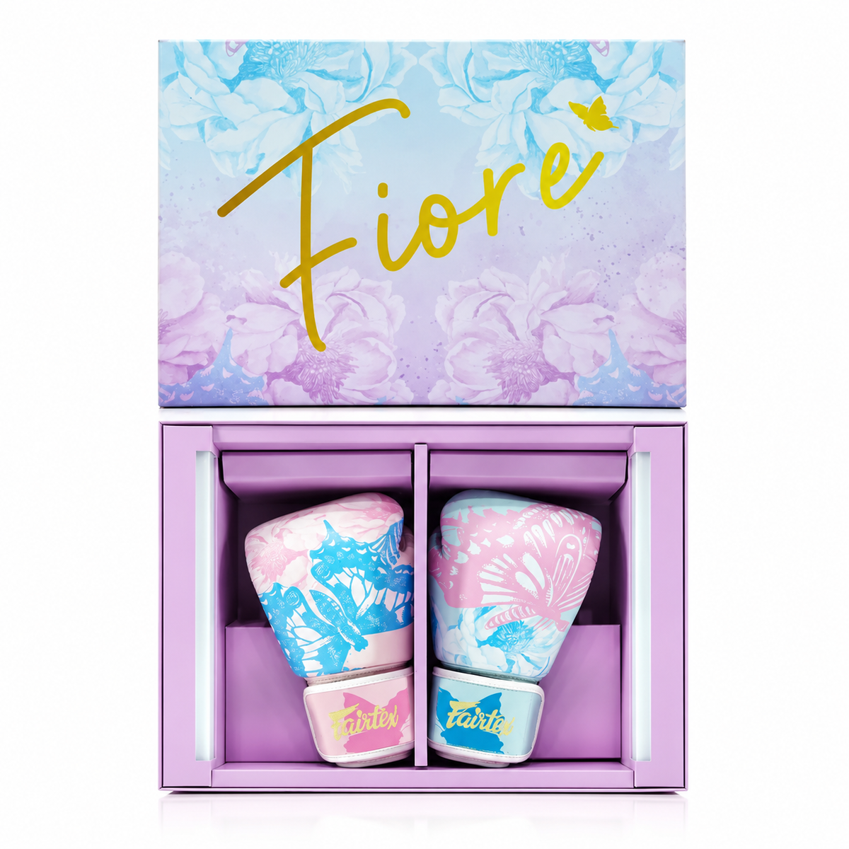 A boxed fragrance gift set labeled Fiore, showing two decorative perfume bottles inside a lavender presentation box with a floral lid. The bottles are pink and blue with butterfly and floral motifs, and the word Fiore is printed on both the lid and the bottle labels.