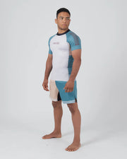 Person wearing a white and blue athletic outfit on a white background