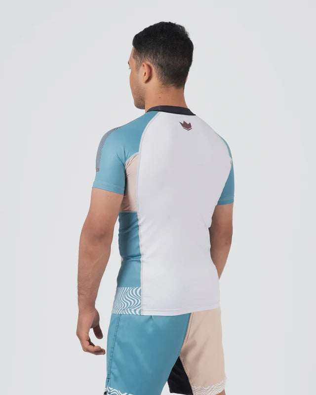 Person wearing a colorful athletic outfit with a visible brand logo on a white background