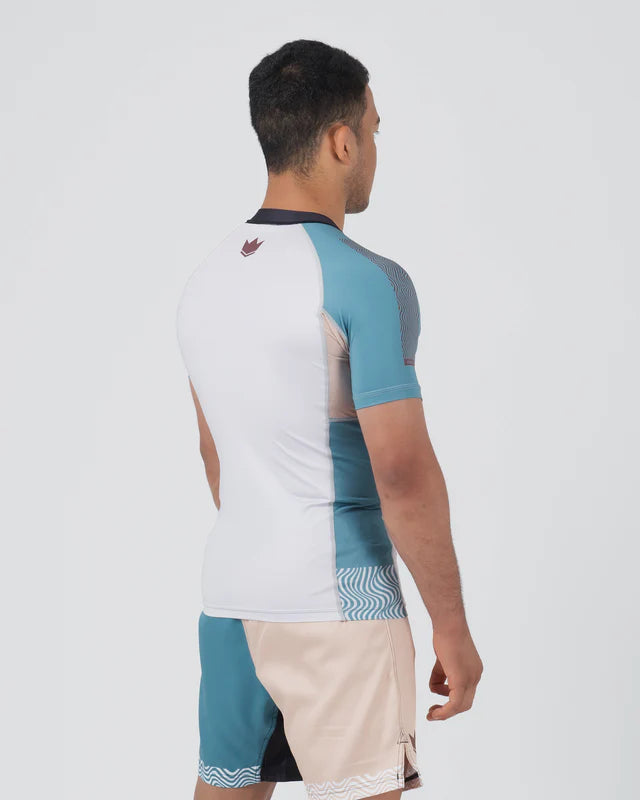Man wearing a color-blocked shirt and shorts on a white background