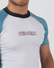 White and blue athletic shirt with 'KINGZ' branding on a gray background