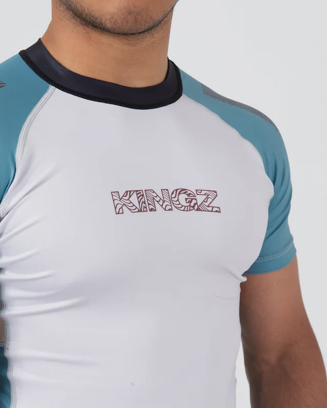 White and blue athletic shirt with 'KINGZ' branding on a gray background