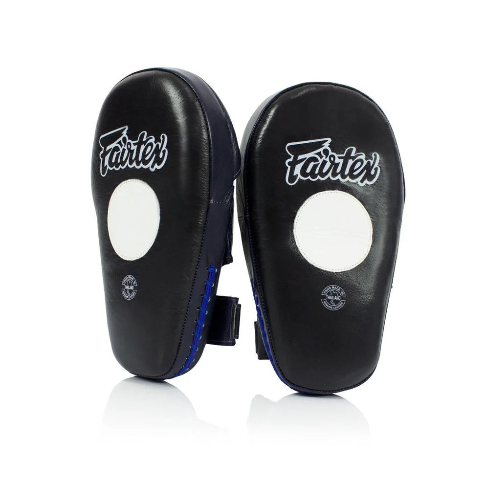 A pair of black Fairtex focus mitts with white circular targets and white Fairtex logos, displayed on a clean white background with a subtle reflection.