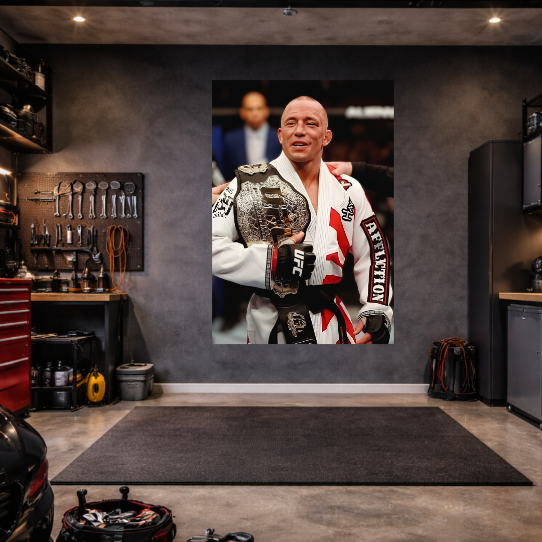 Man holding a championship belt in a garage setting with tools and equipment.