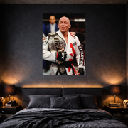 Man in a white martial arts uniform holding a championship belt above a bed with black bedding.