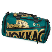Green duffel bag with gold and black designs on a white background