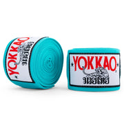 Turquoise Yokkao boxing hand wraps on a white background