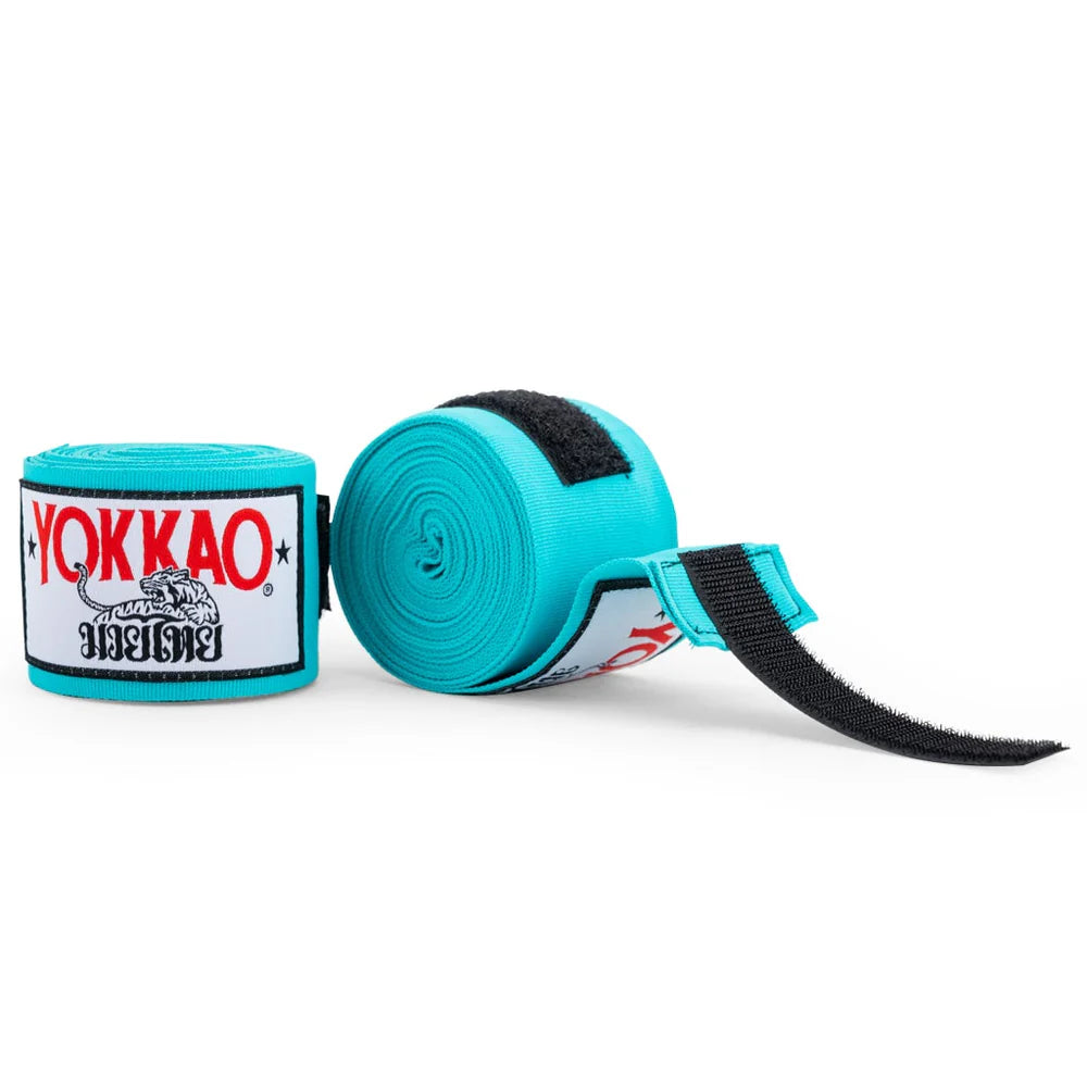 Turquoise hand wraps with Yokkao branding on a white background