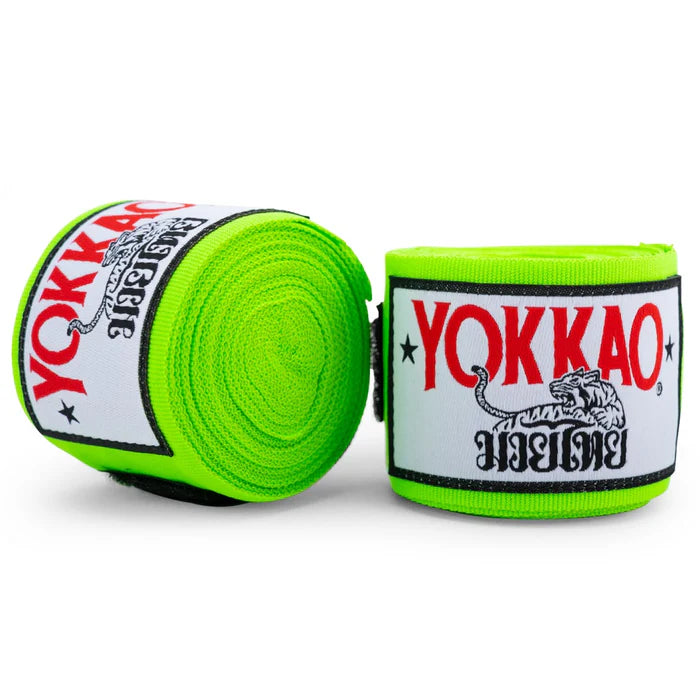 Two rolls of green Yokkao boxing hand wraps on a white background