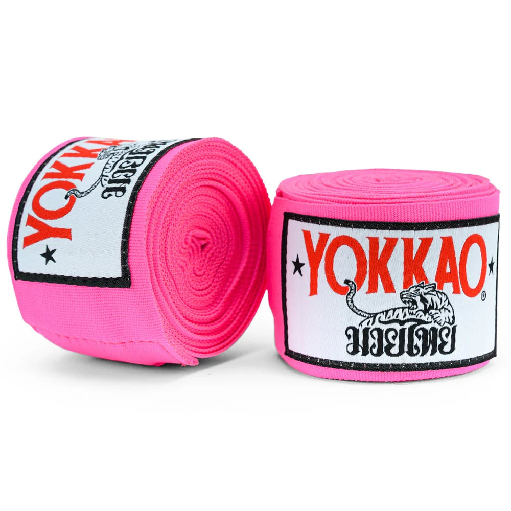 Two rolls of pink Yokkao hand wraps on a white background