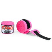 Pink hand wraps with black straps and Yokkao branding on a white background