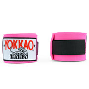 Pink wrist wraps with Yokkao logo on a white background