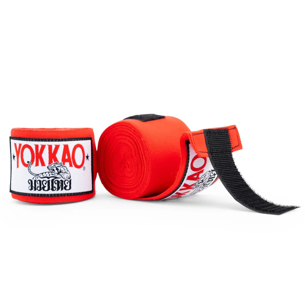 Red boxing hand wraps with black straps and YOKKAO branding on a white background