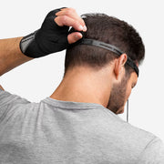 Person wearing a black headband with a gray shirt on a white background