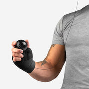Person using a black wrist support device on a white background