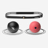 Black and red exercise balls with a black resistance band on a white background