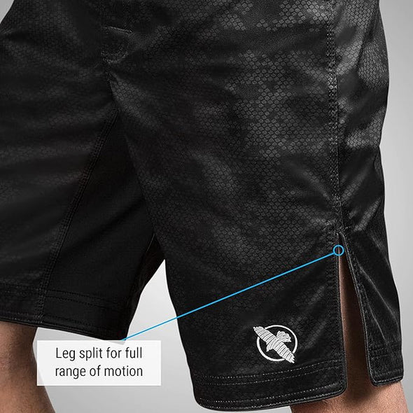 Black shorts with a leg split feature on a gray background
