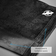 Close-up of black fabric with a pattern and a brand logo, highlighting stretch panel and reinforced seams.