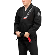 Person wearing a black martial arts uniform with visible branding on a white background