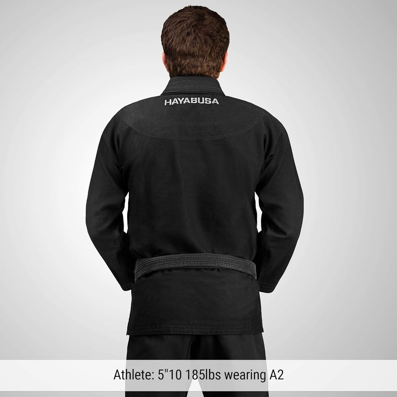 Person wearing a black Hayabusa martial arts gi on a gray background