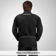 Person wearing a black Hayabusa martial arts gi on a gray background