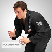 Person wearing a black BJJ gi with Hayabusa branding on a gray background