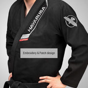 Person wearing a black martial arts uniform with Hayabusa branding on a gray background