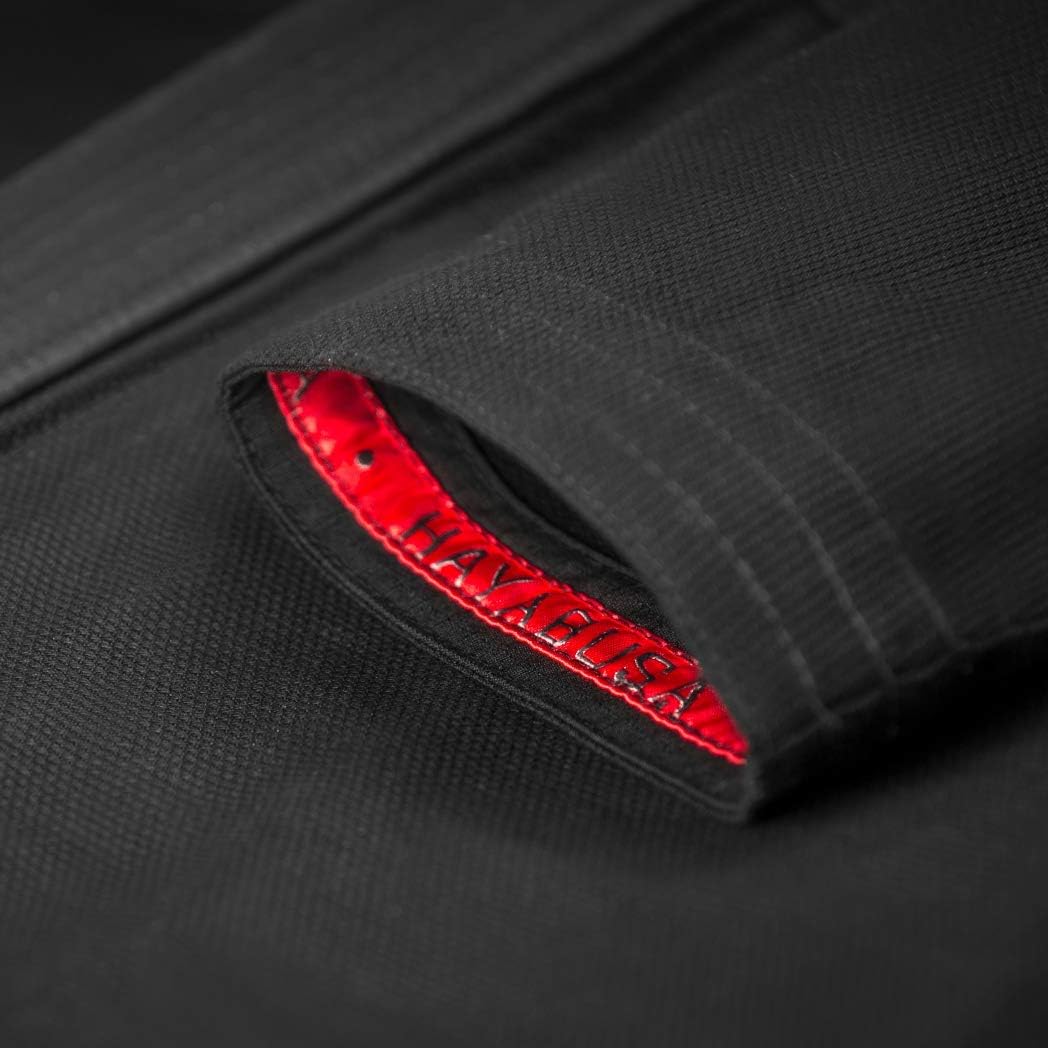 Close-up of a black garment with red stitching detail